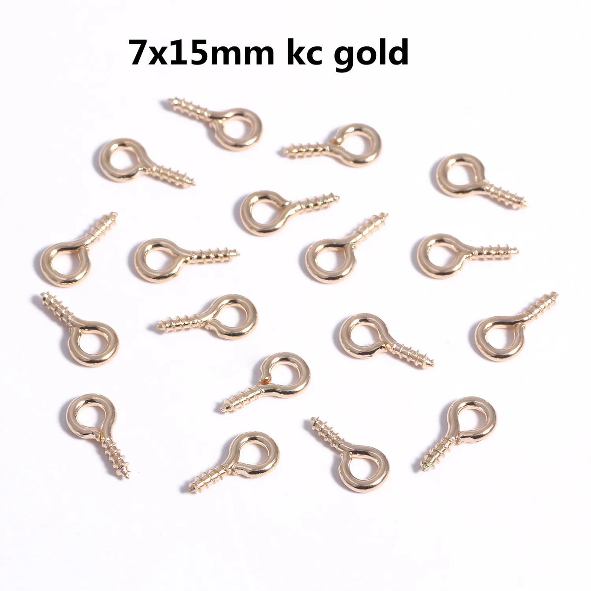 A collection of gold mini eye pins with screw threads for jewelry making.