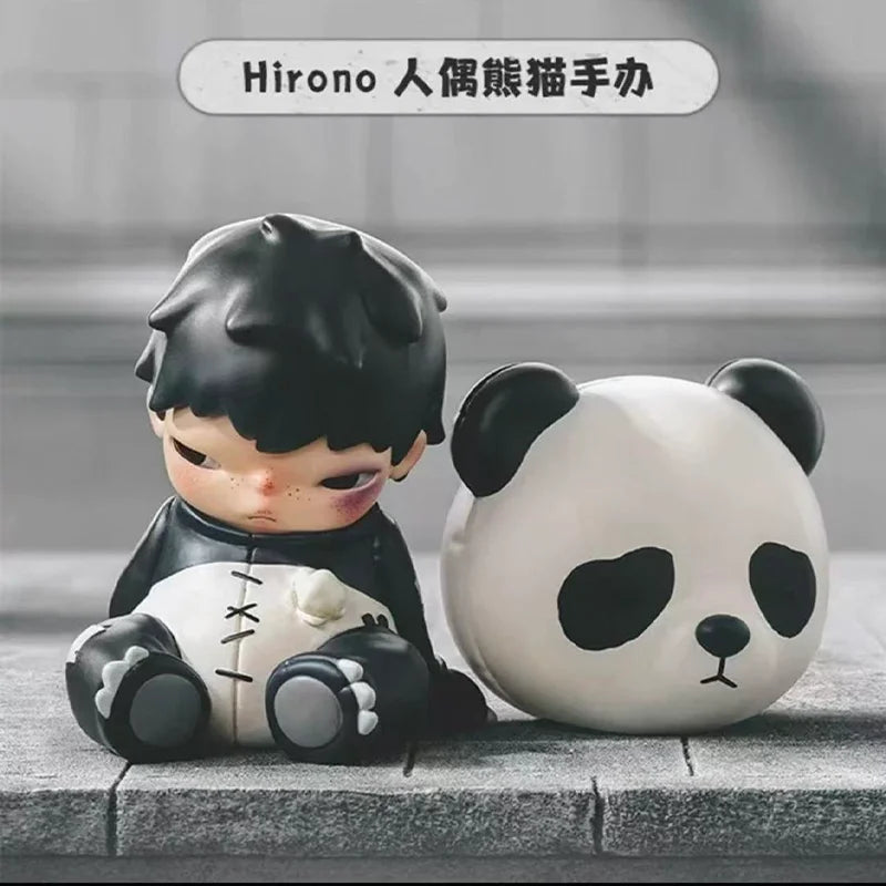 A collectible figure of a black-haired character next to a white panda figure.