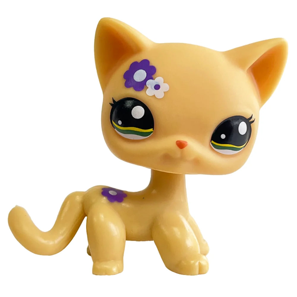 A yellow cat bobble head figurine with purple and white floral markings.