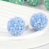 Light blue rose flower ball acrylic beads with pearl accents arranged on a white surface.