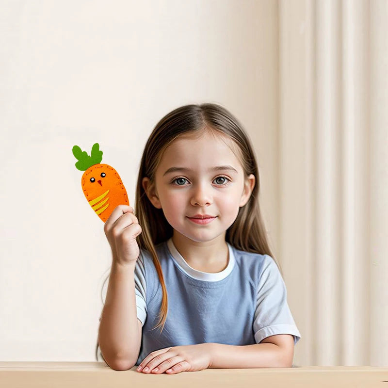 A young girl holds an orange carrot felt craft kit for kids in a bright indoor setting.