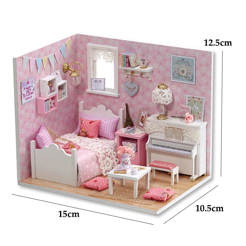 A pink miniature dollhouse kit featuring a crib, furniture, and decorative items for a kitten theme.