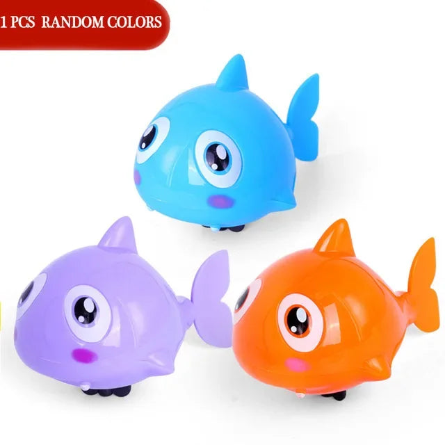 Three plastic swimming turtle toys in blue, purple, and orange colors