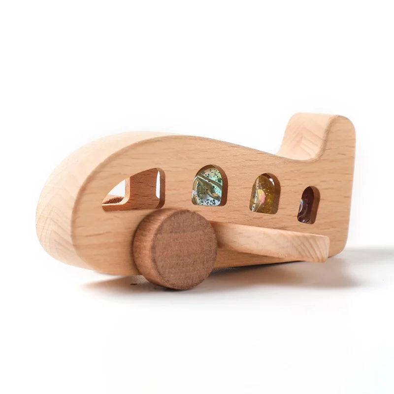 A light wooden train toy featuring cut-out windows filled with colorful glass beads for Montessori educational play.