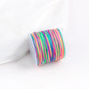 A roll of multicolored macrame cord in various shades of green, pink, and yellow for jewelry making.