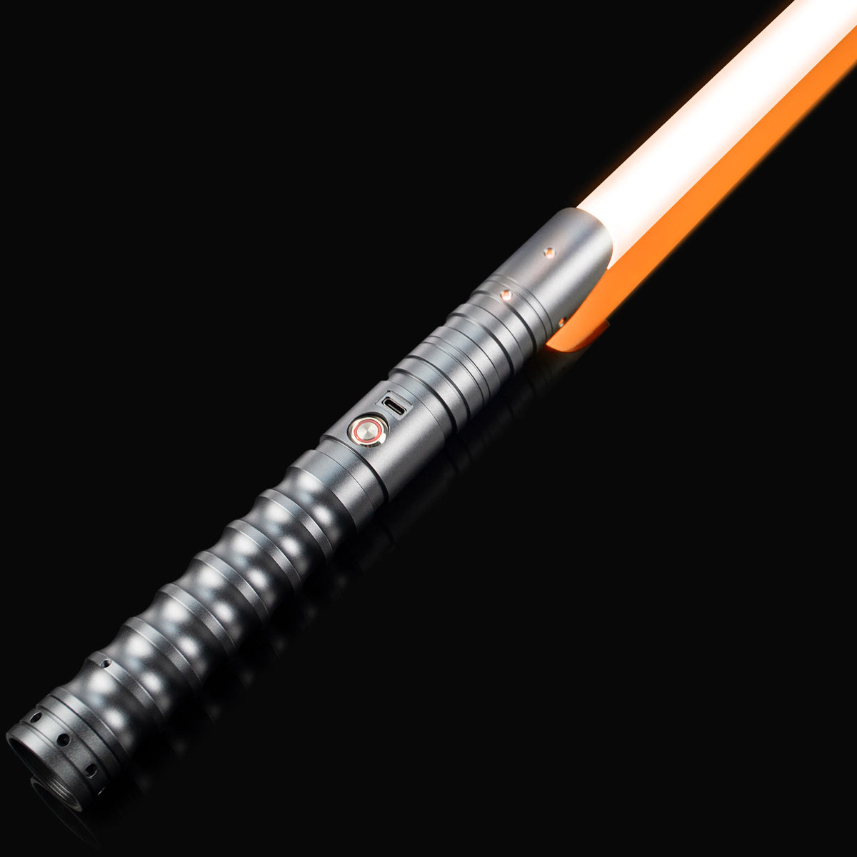 A close-up view of a heavy dueling lightsaber with an orange hilt and glowing white blade against a black background.