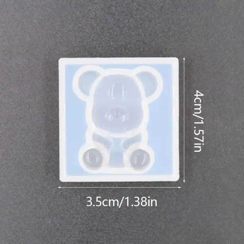 A clear silicone mold shaped like a bear for resin jewelry and crafts.