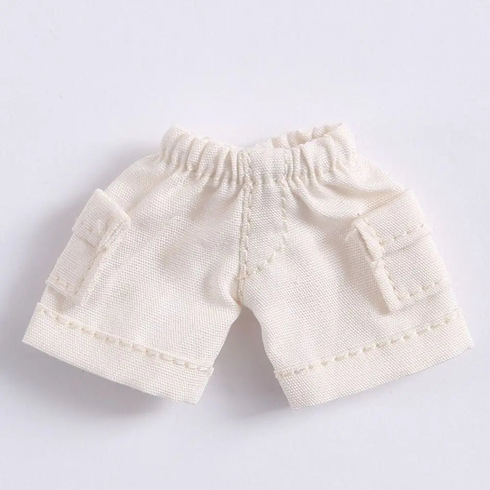 Shorts en jean crèmes mini pour accessoires de poupée avec poches visibles et élastique