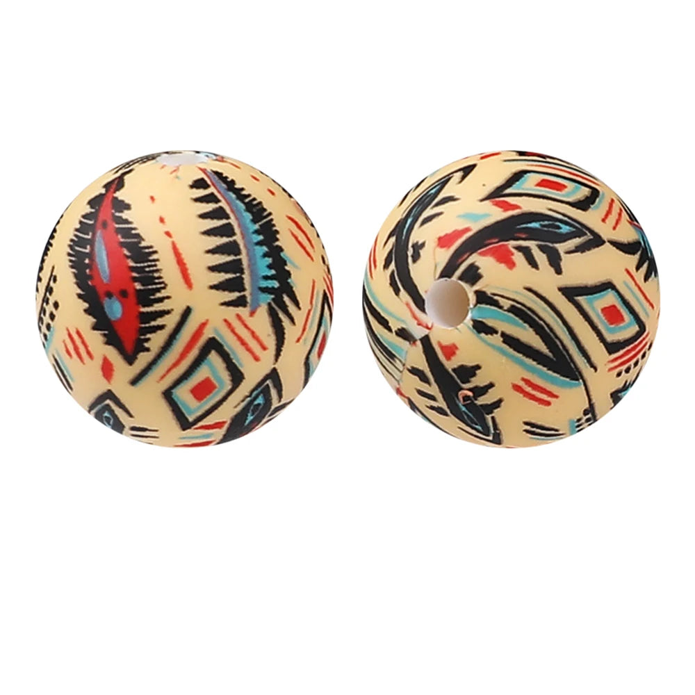 Two round silicone beads with intricate geometric patterns in black, red, and blue designs