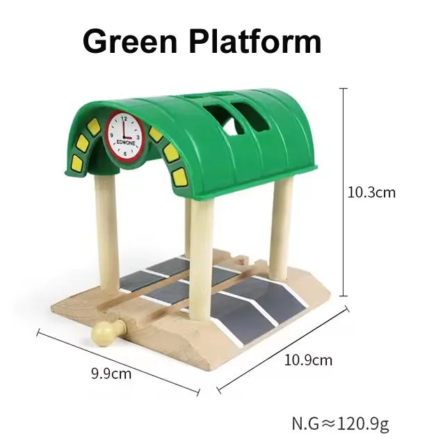 A green platform model featuring a clock and wooden track pieces for creative railway play.