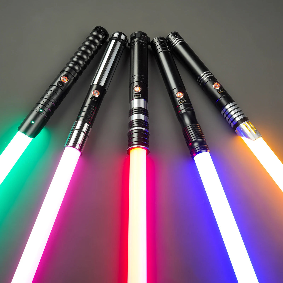 A collection of black lightsabers with glowing blades and colorful lights arranged diagonally against a dark gray background.