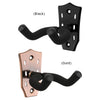 A pair of guitar wall mounts, one black and one gold, featuring padded hooks for hanging guitars.