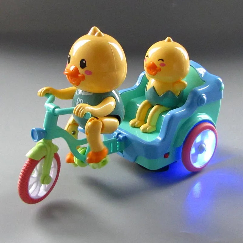 A yellow duck figure is seated in a teal electric tricycle with pink wheels and blue lights.