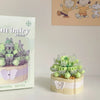 A miniature flower bouquet building block set featuring green and purple blocks and a butterfly shape.