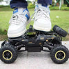 A black 4WD off-road monster truck with white and blue accents is shown on a concrete surface.