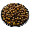 A pile of small, round, amber-colored acrylic beads for jewelry making.