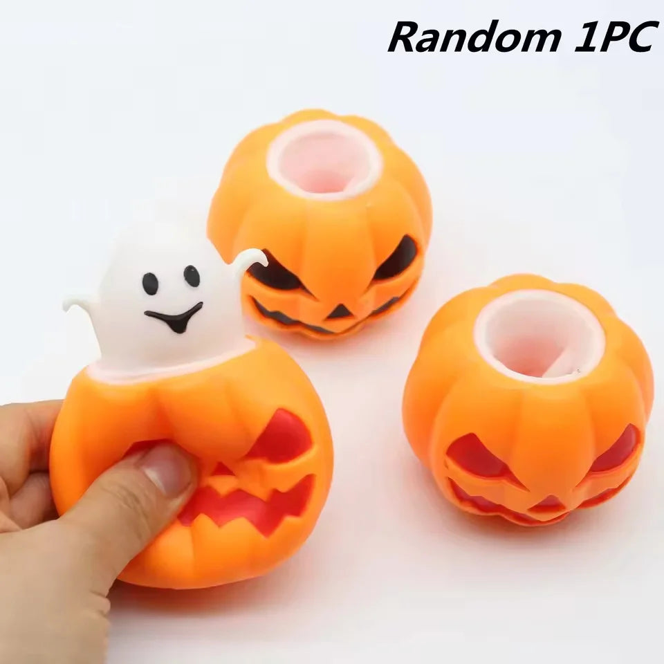 A hand holds an orange squishy ghost and pumpkin fidget toy with a white ghost figure inside.