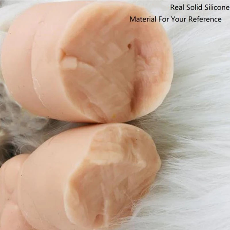 A close-up view of a realistic soft silicone piglet mini doll in a light pink color resting on white fur.