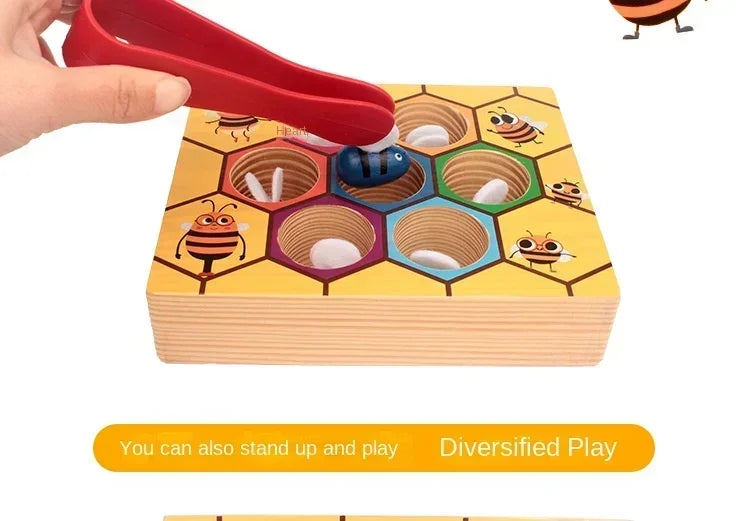 A hand is placing a red clip onto a wooden bee trap game featuring various colored hexagonal beads and insect figures.