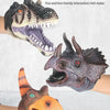 A hand puppet of a dinosaur, featuring realistic textures and colors, being held by a person.
