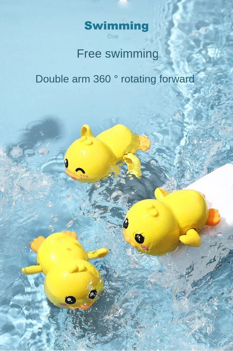 A yellow wind-up swimming duck toy floating in clear water.