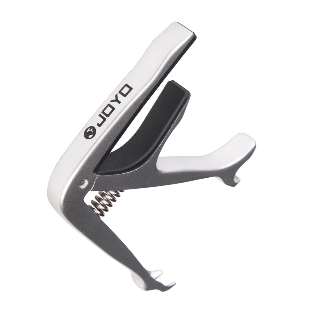 Silver zinc alloy guitar capo with a black plastic body and metal hinge
