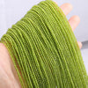 A hand holds a strand of bright lime green faceted natural stone beads for DIY jewelry making