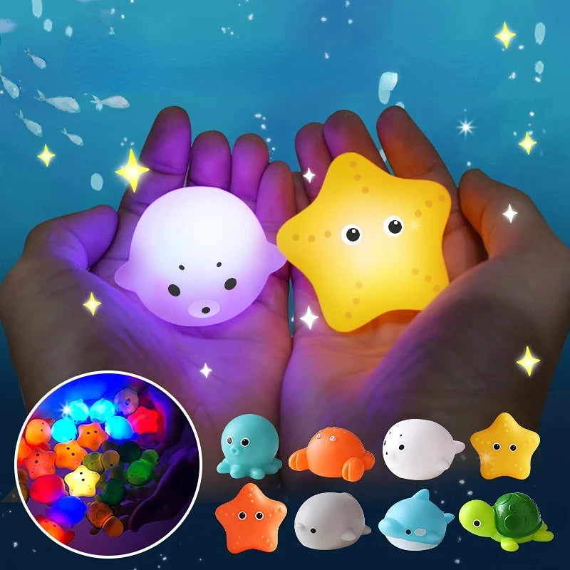Hands hold glow-in-the-dark animal washing water toys including a white pig and a yellow star.