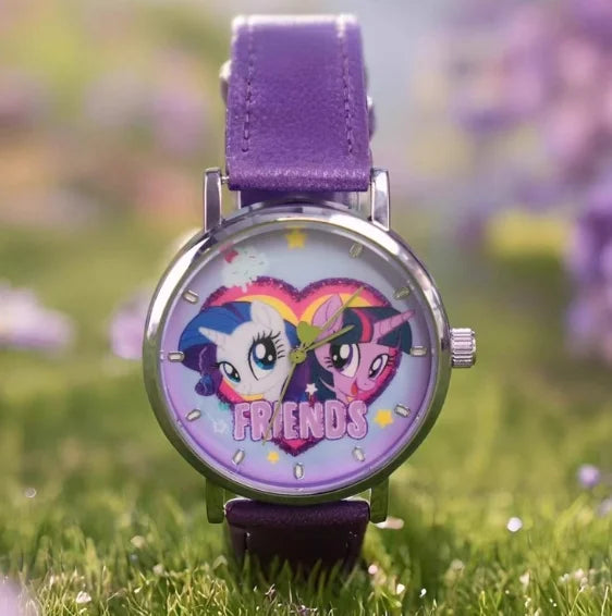 A purple strap watch featuring a My Little Pony Magic Sweetheart design on the face, set against a blurred green background.