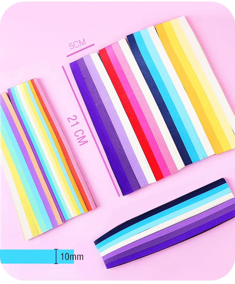 A collection of 27 colorful, striped paper strips laid out on a pink background.