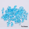 A pile of small, translucent blue glass beads shaped like tulip flowers.