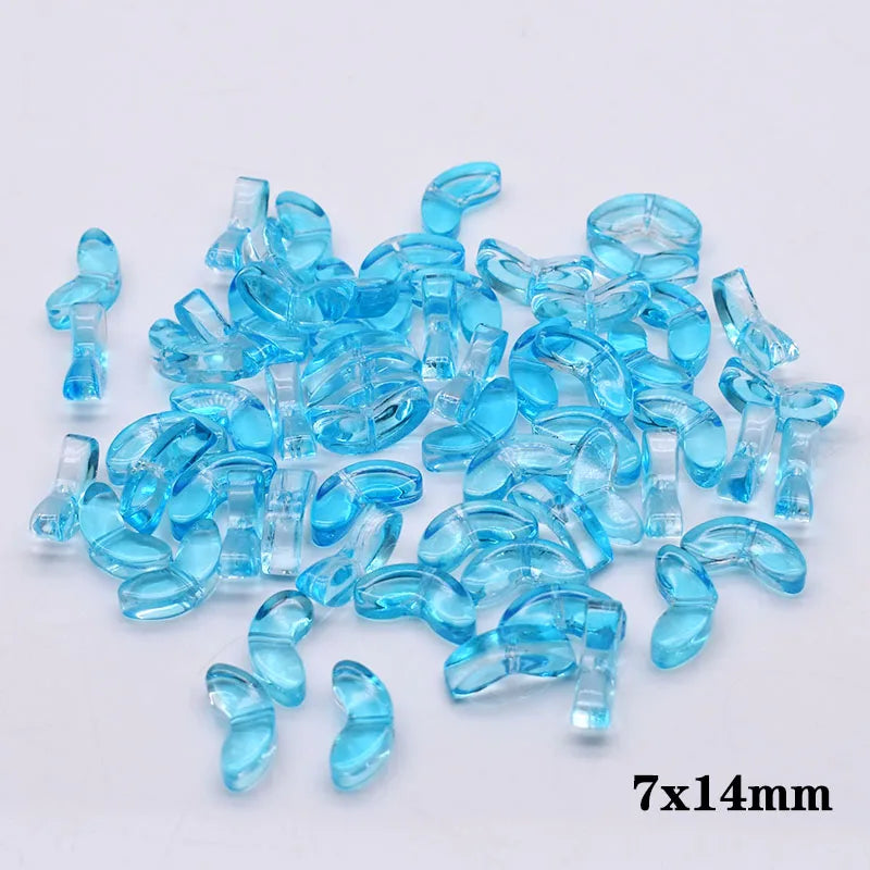 A pile of small, translucent blue glass beads shaped like tulip flowers.