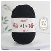 A ball of black chenille yarn labeled with Chinese characters for knitting and crochet.