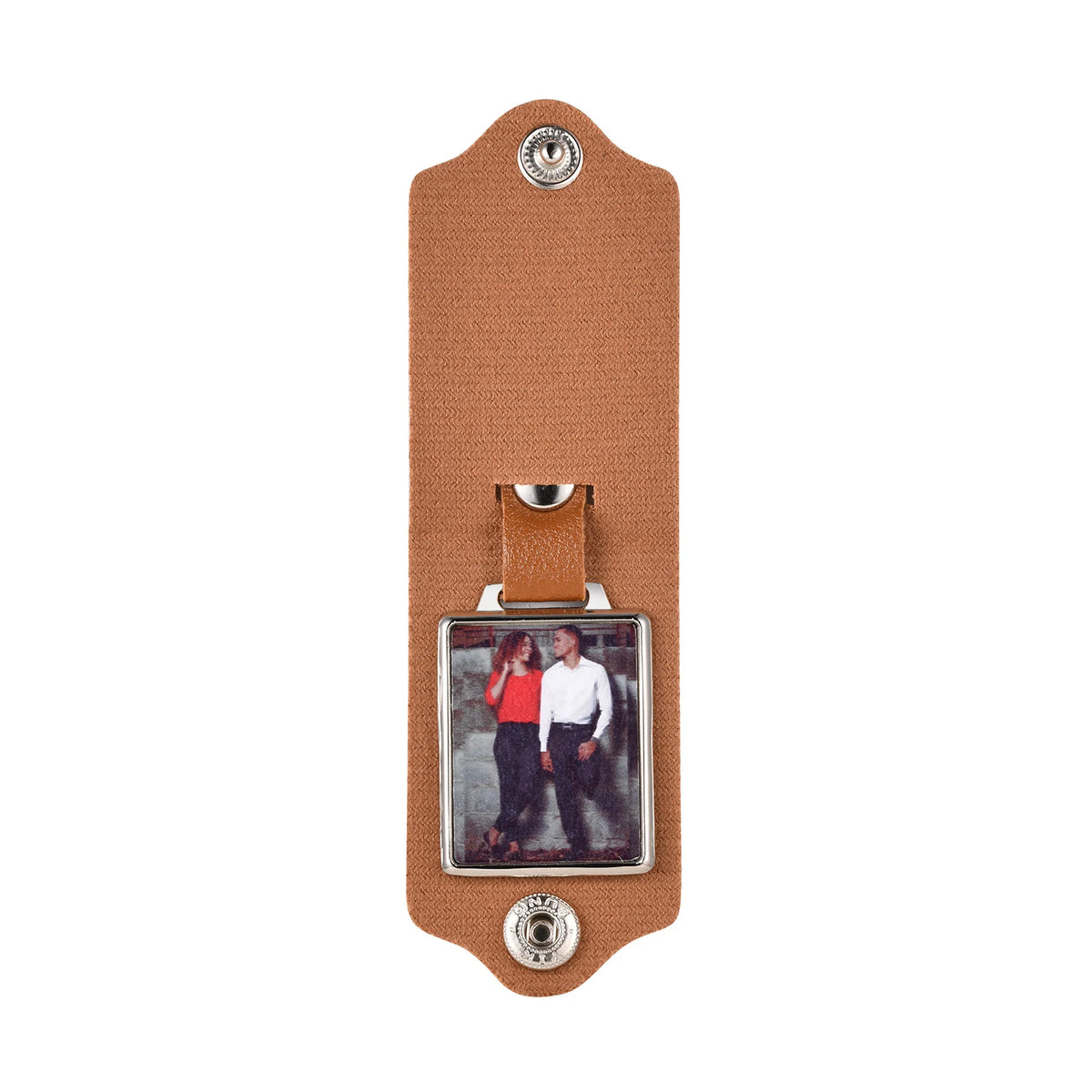 A brown leather keychain featuring a custom photo and personalized engraving.