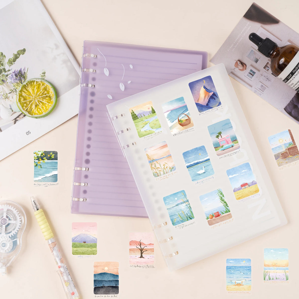 A collection of decorative stickers featuring mountain and sea scenery on a white page surrounded by purple and beige station