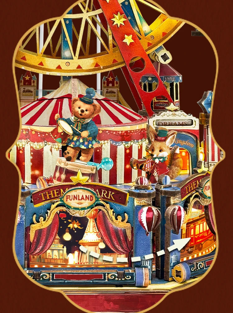 A detailed wooden model kit of a fairground scene featuring a Ferris wheel, rides, and a music box dollhouse.