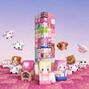 A collection of pink and white magnetic building blocks shaped like characters and castle structures.