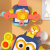 A colorful Busy Box toy featuring a wooden cube with various sensory components and a small animal figure.