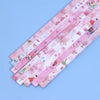 A collection of 27 assorted pink and white origami star strips for DIY crafting and decor.