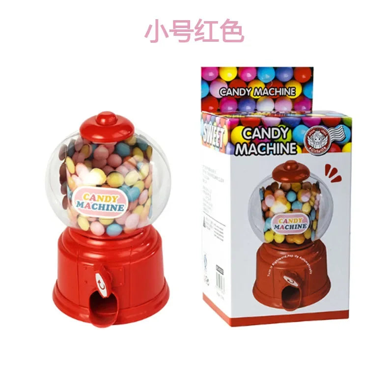 A red candy machine dispenser with a clear globe showing colorful candies and a cardboard box labeled Candy Machine