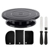 A black cake decorating kit featuring a rotating turntable, spatulas, and scrapers.