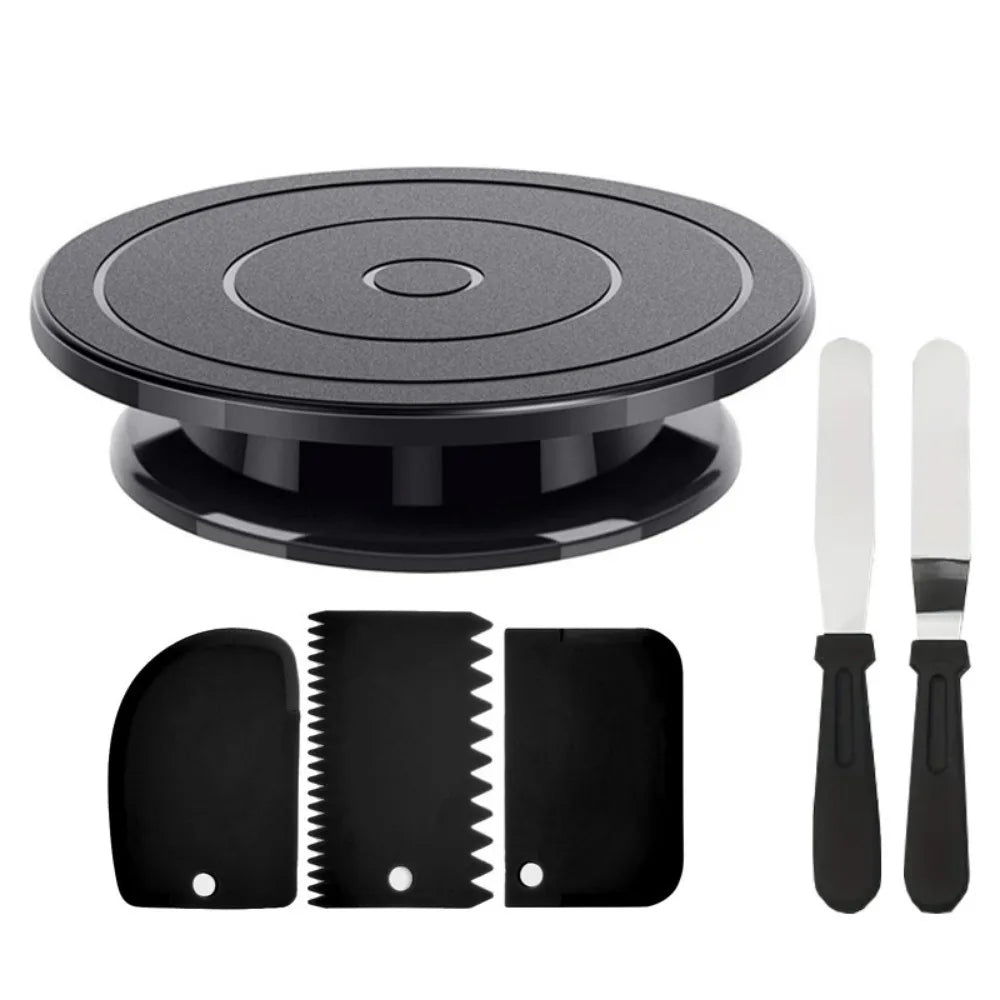 A black cake decorating kit featuring a rotating turntable, spatulas, and scrapers.