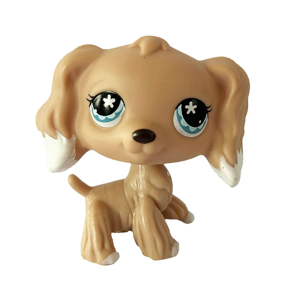 A beige bobblehead toy of a dog with large blue eyes and white accents.