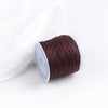 A roll of dark reddish-brown cotton nylon macrame cord for jewelry making and crafts.