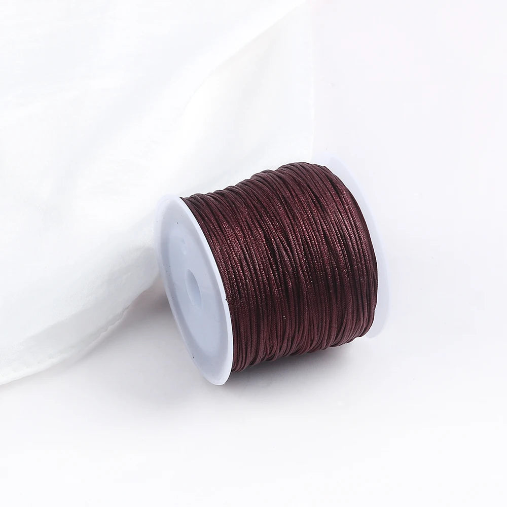 A roll of dark reddish-brown cotton nylon macrame cord for jewelry making and crafts.