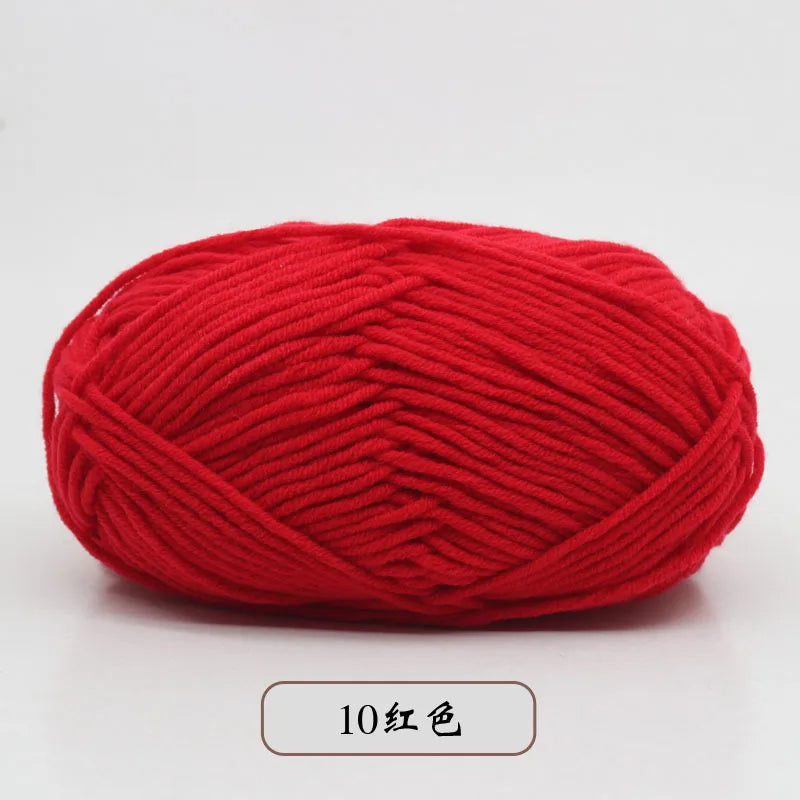A ball of bright red pre-dyed milk cotton yarn used for knitting and crochet.