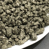 A close-up view of natural crystal chips, including chalcopyrite and pyrite mineral decor.