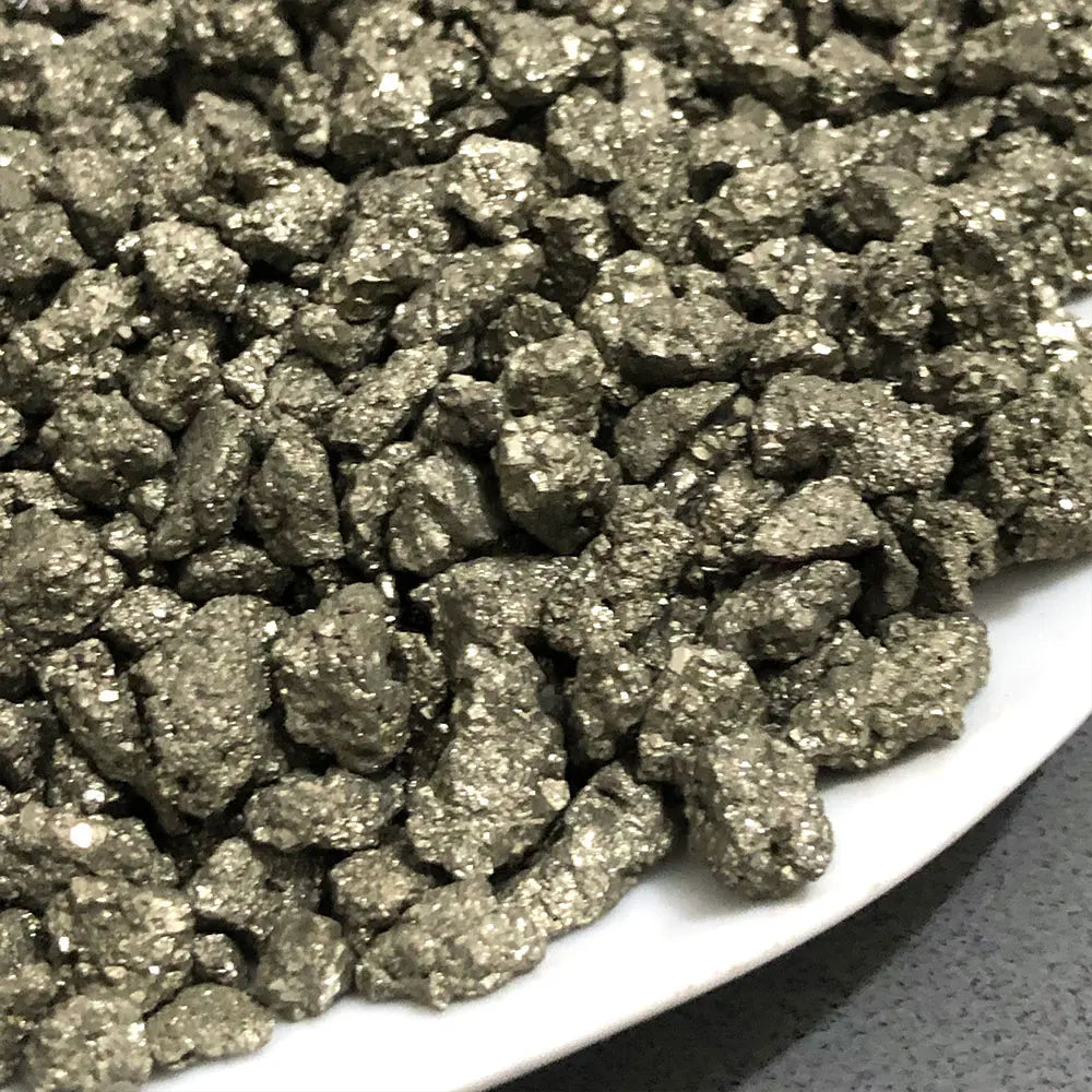 A close-up view of natural crystal chips, including chalcopyrite and pyrite mineral decor.