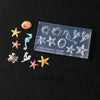 A clear silicone mold contains various 3D nail art designs including sea shells, starfish, and ocean creatures.