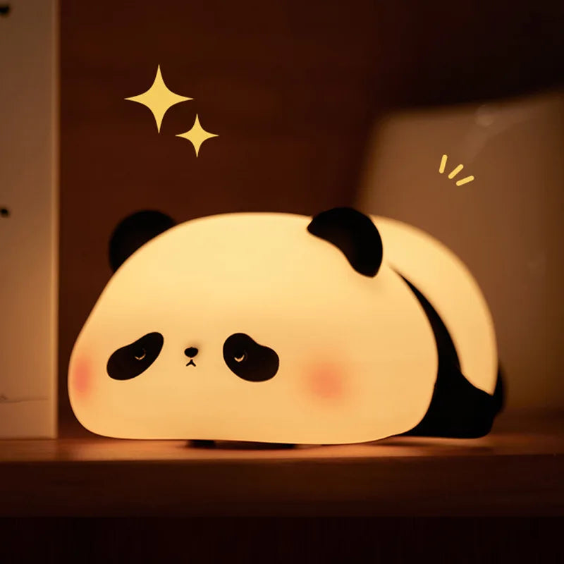 A glowing white silicone panda night light with black ears and eyes, featuring sparkling star accents.